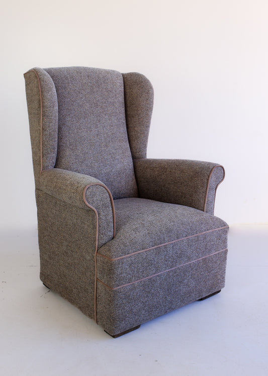 A Pair of Vintage Wingback Rocking Chairs