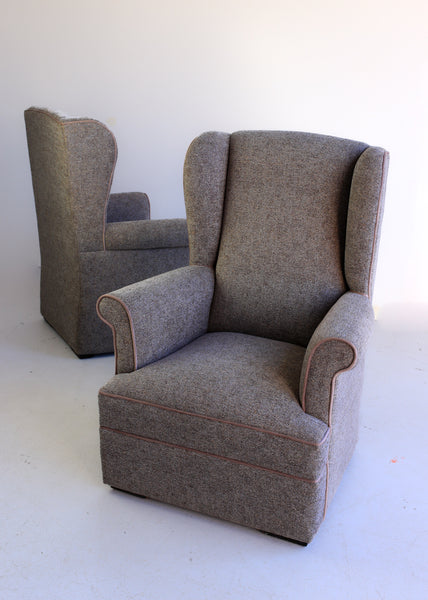 A Pair of Vintage Wingback Rocking Chairs